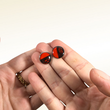 Carica l'immagine nel visualizzatore di Gallery, Orecchini a bottoncino con fibra di fico d'india sotto resina e sfondo rosso (codice R01). Base tonda anallergica nickel free in acciaio inox. Dimensione: L - 1,4 cm Ogni gioiello viene lavorato e preparato con cura; le caratteristiche della fibra naturale e della resina rendono ogni pezzo unico e irriproducibile.